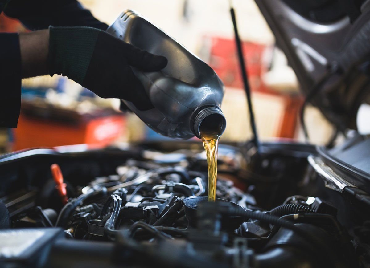 Oil Ninja mobile technician performing oil change at residential home in Springdale Arkansas